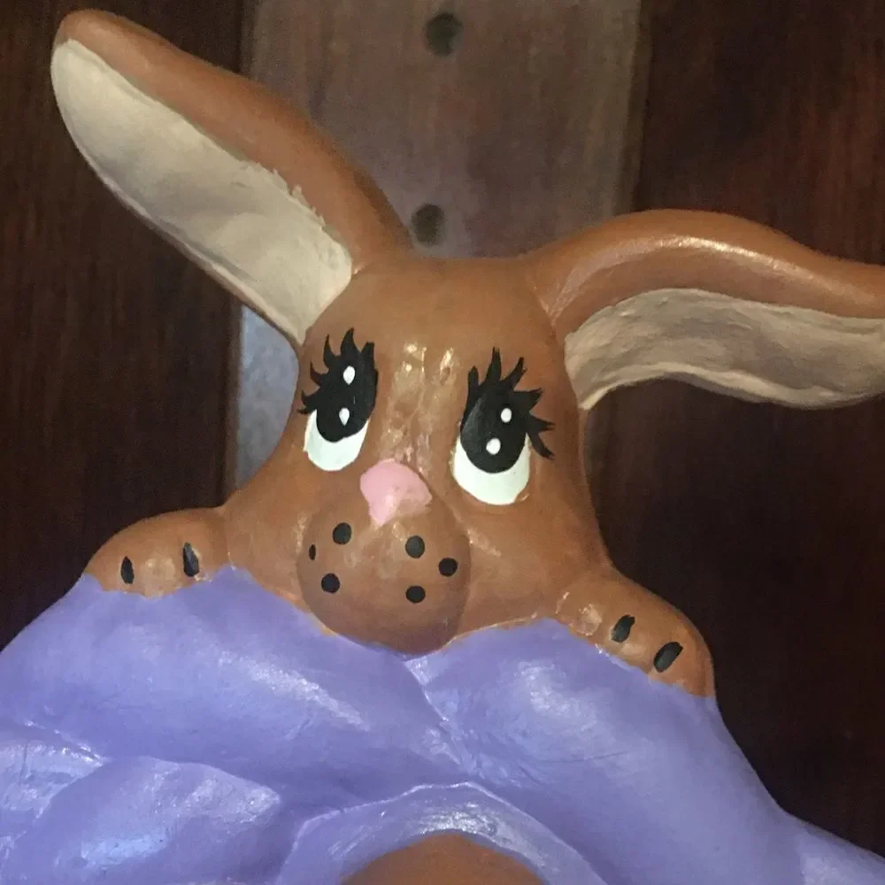 Ceramic Easter bunny hanging from basket